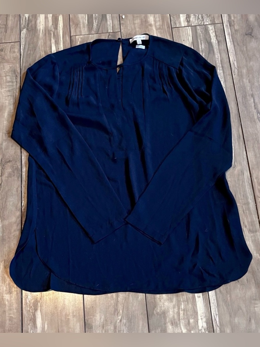 Rose & Olive brand navy blue long-sleeve blouse with pleated details
